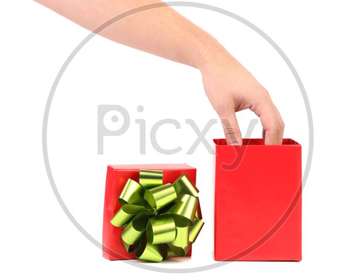Red Gift Box With A Hand On It With Green-Golden Bow.