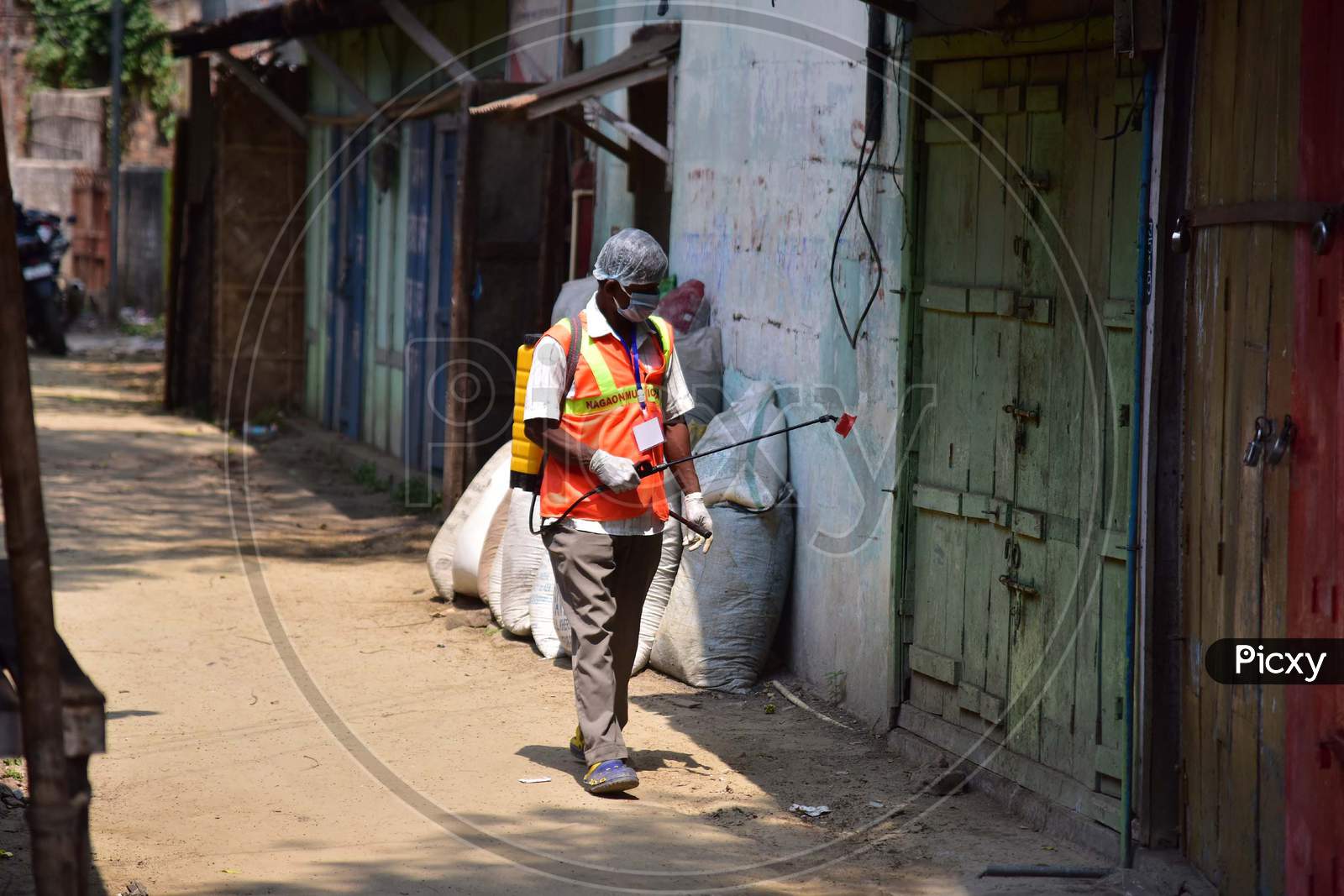 A Municipality Worker Spray Disinfectant During India Government-Imposed Lockdown As A Preventive Measure Against The Covid-19 Coronavirus In Nagaon District Of Assam ,India