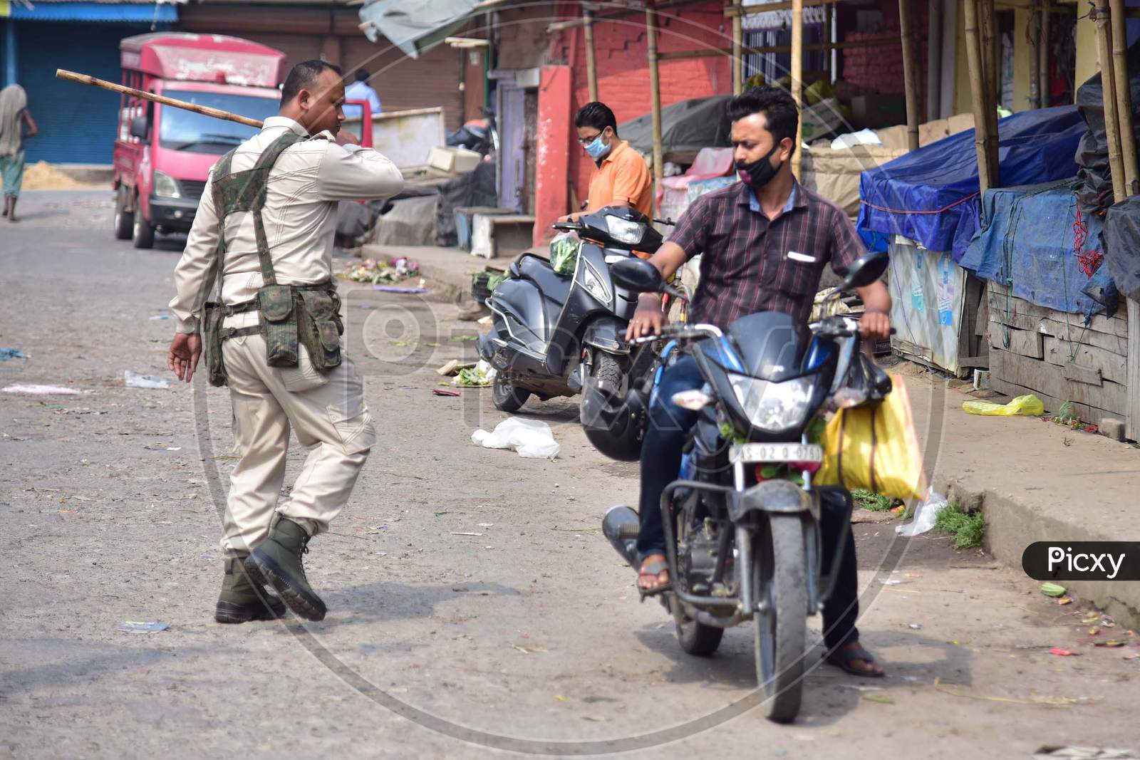 A Police  Officer Wields His Baton Against A Man As A Punishment For Breaking The Lockdown Rules After India Ordered A 21-Day Nationwide Lockdown To Limit The Spreading Of Coronavirus Disease (Covid-19) In Nagaon District Of Assam,India
