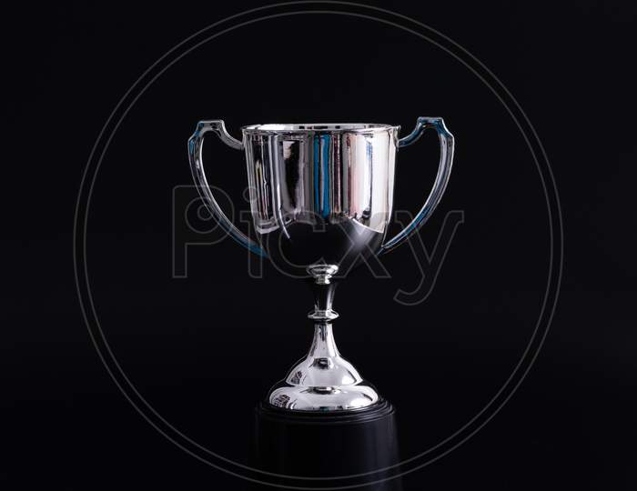 Silver Trophy Isolated On Black Background With Copy Space. Concept Winner