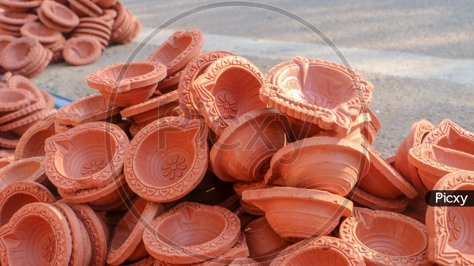 Clay diyas or oil lamps for Diwali for sale at a market in India