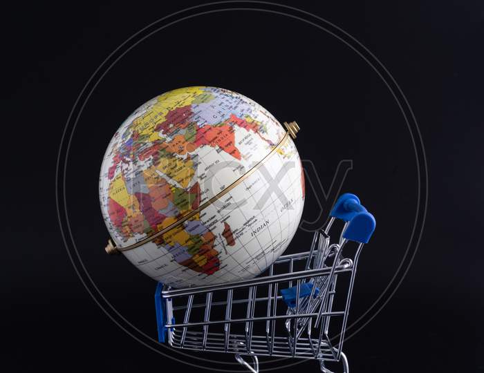 Mini Shopping Cart Trolley And Globe Model With Black Background