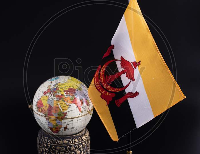 Globe,Brunei Flag And Vase Isolated On Black Background