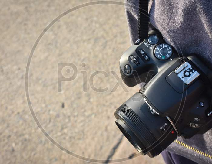 digital black slr camera in hand