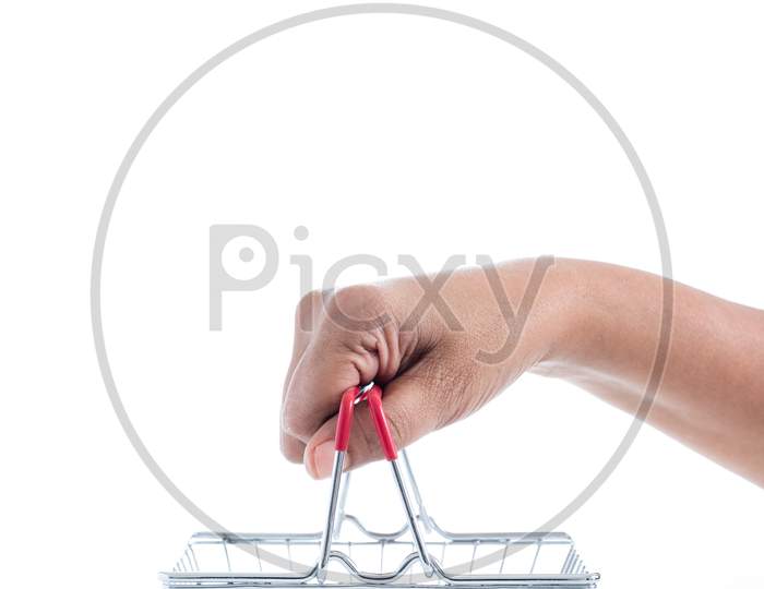 Online Shopping Concept, Sale. Hand Holding Mini Shopping Basket On White Background. Side View