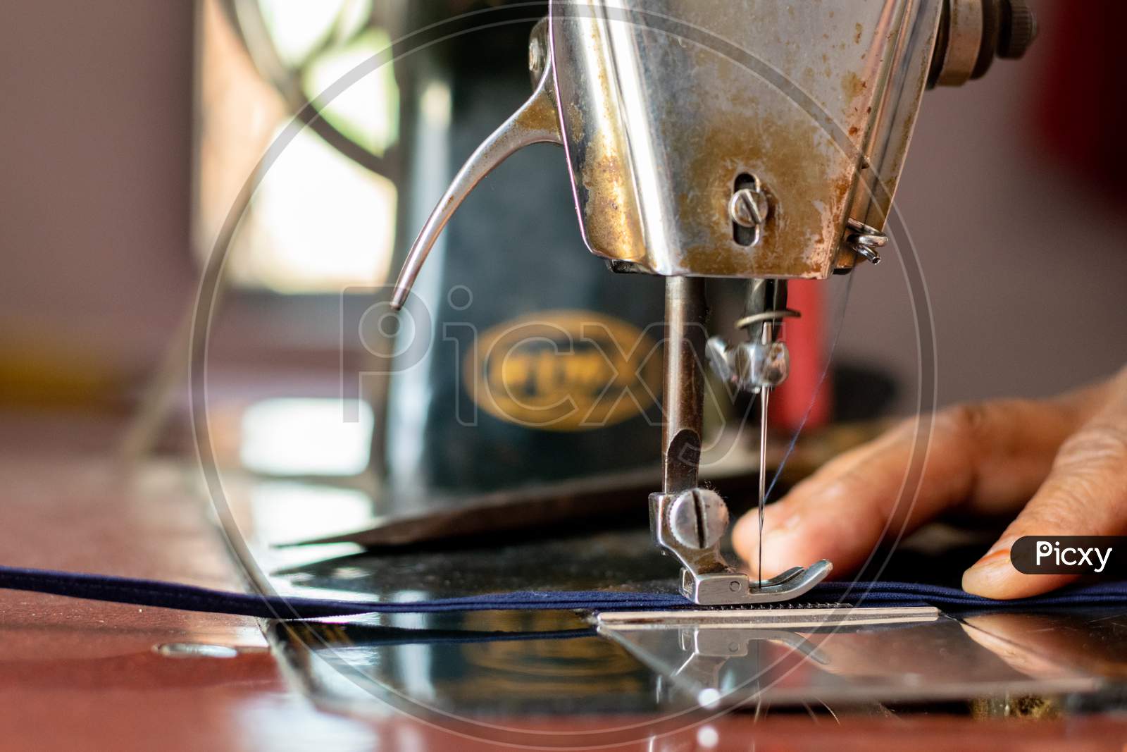 A woman working on sewing machine at home  closeup