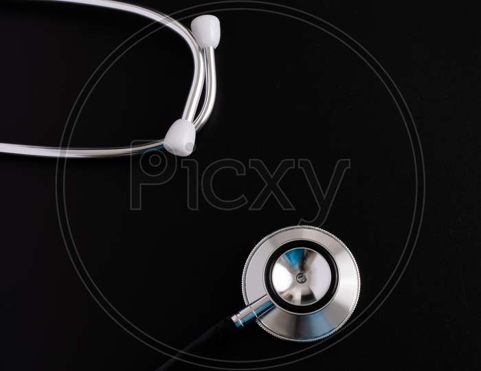 Stethoscope Isolated On Black, Top View. Medical Tool