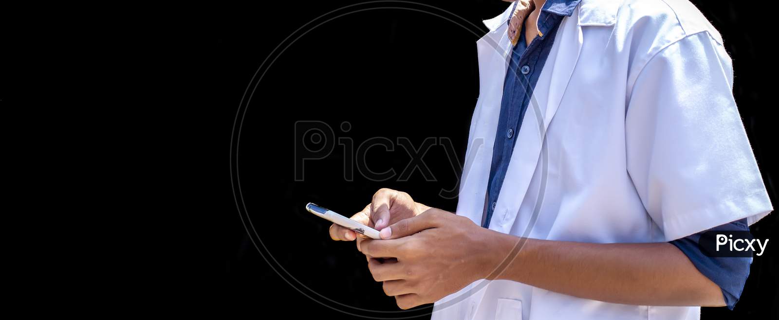 Cropped Shot Of Doctor Using Mobile Smart Phone On Black Backgrounds