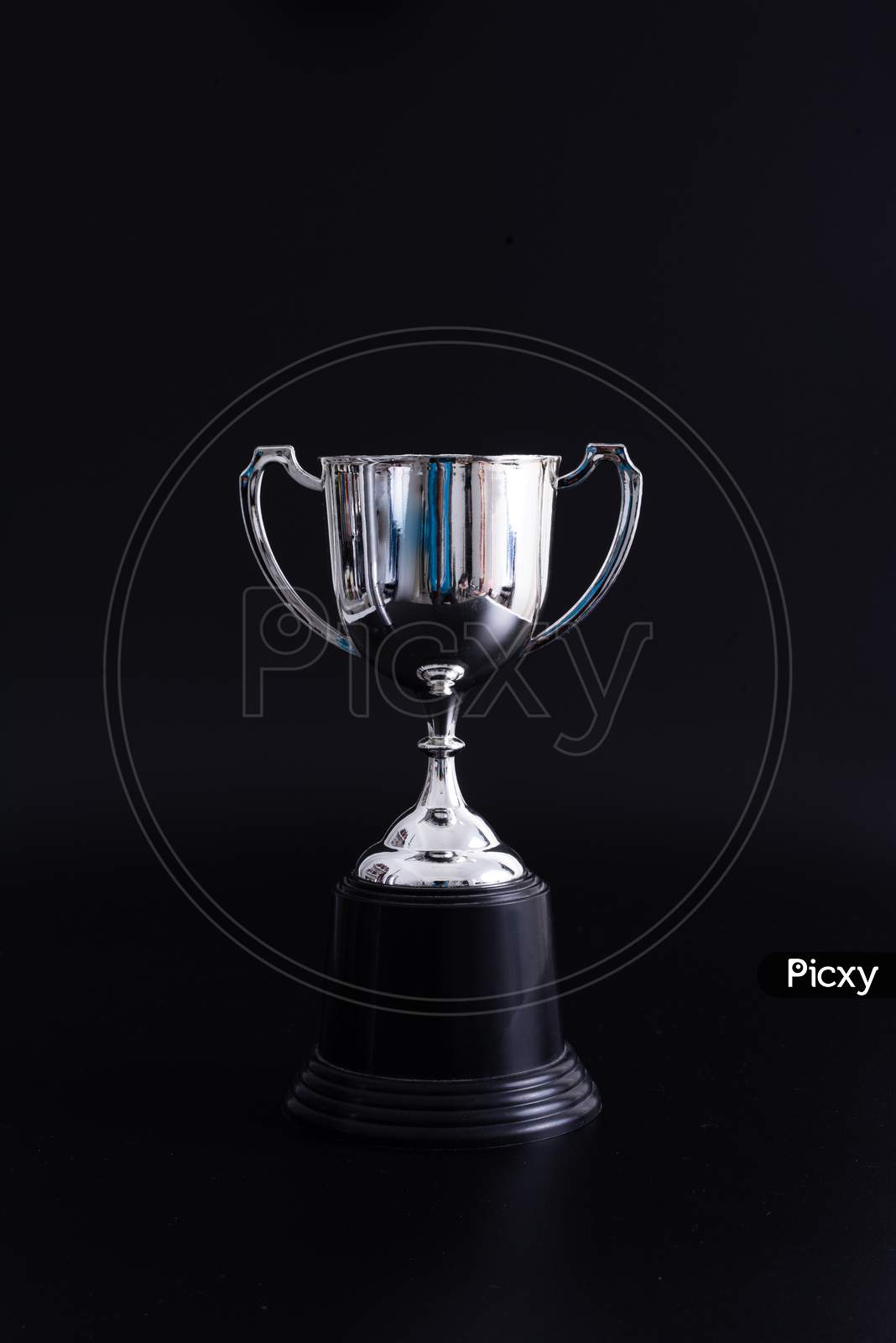 Silver Trophy Isolated On Black Background With Copy Space. Concept Winner