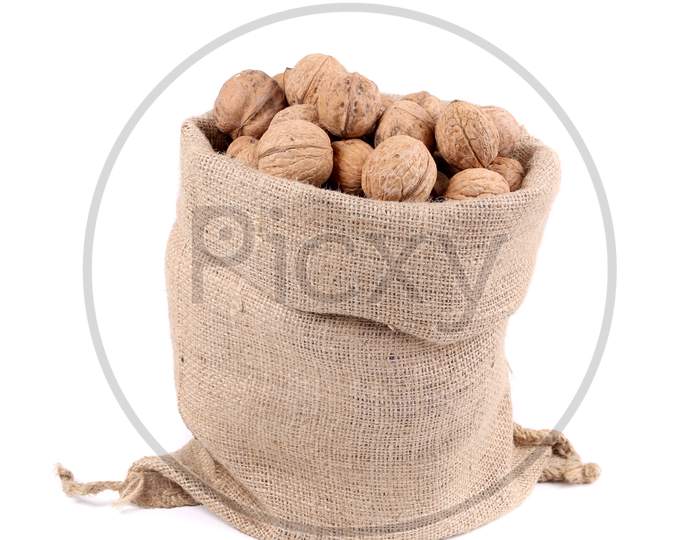 Sack Full Of Walnuts. Close Up. Isolated On A White Background.