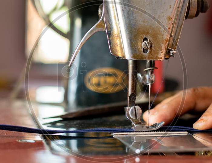 A woman working on sewing machine at home  closeup