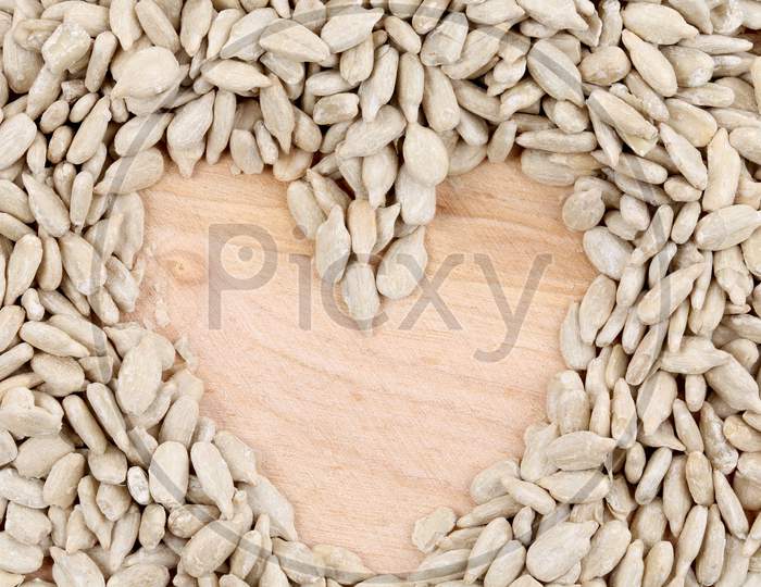 Heart Made Of Seeds On Table. Whole Background.