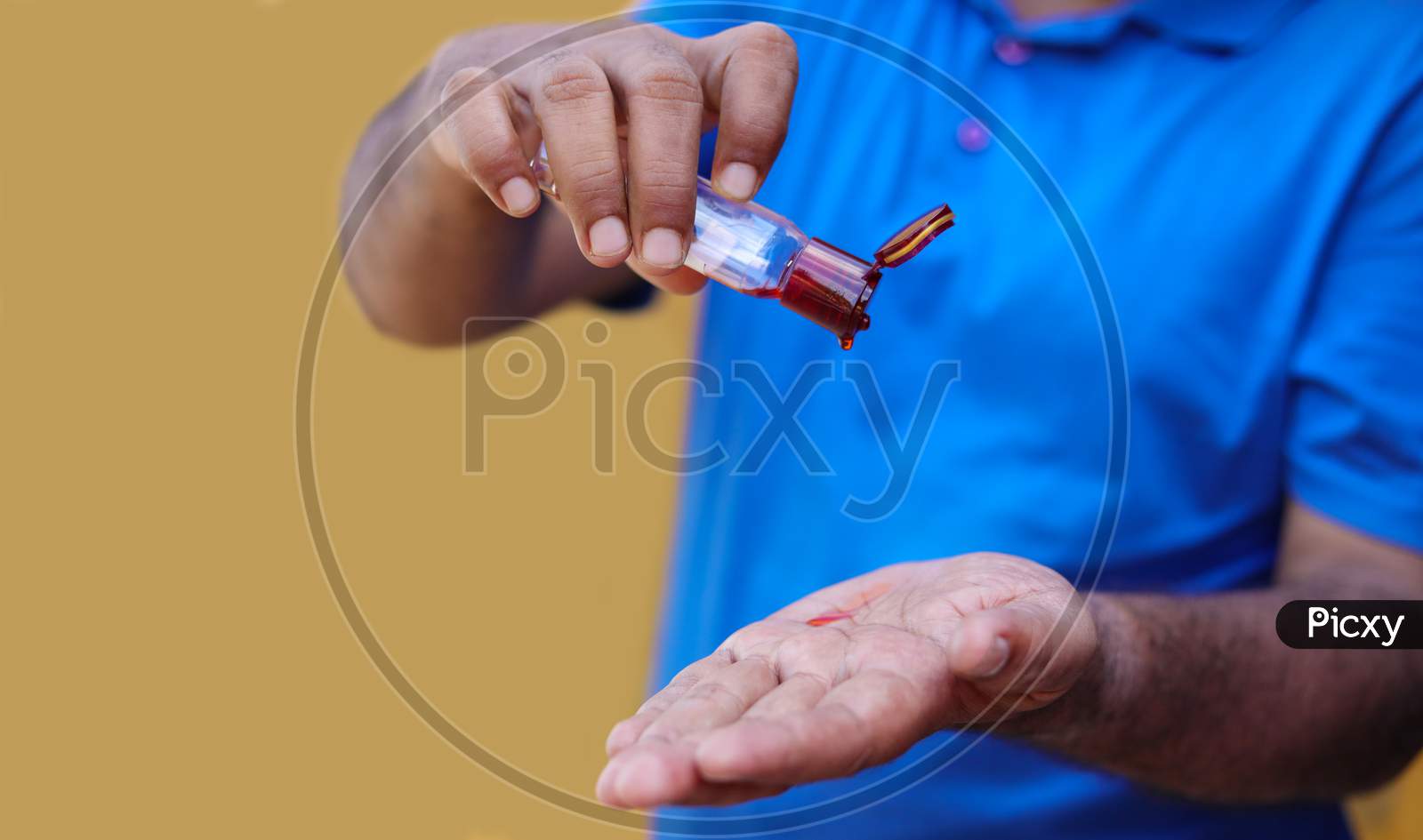 Man Pouring Massage Aroma Oil On Hands