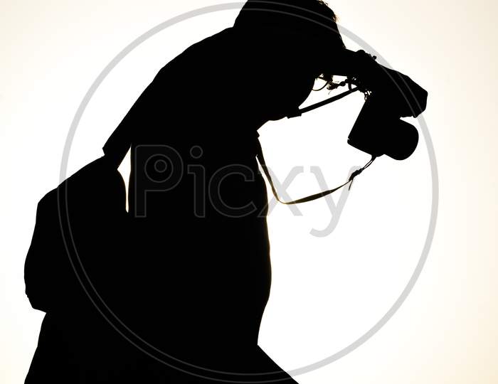 silhouette of photographer with camera