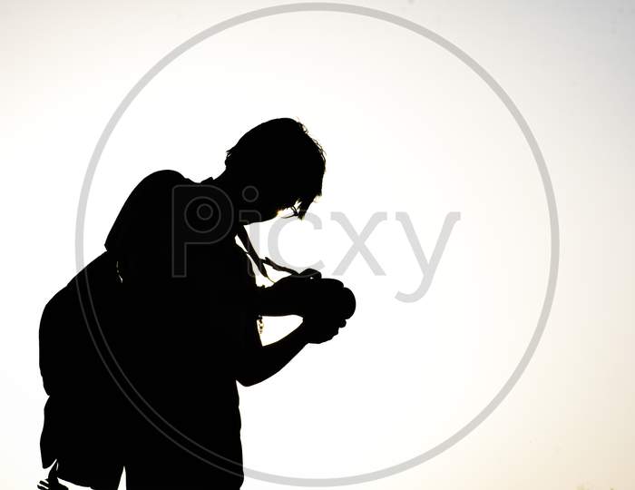 silhouette of photographer with camera
