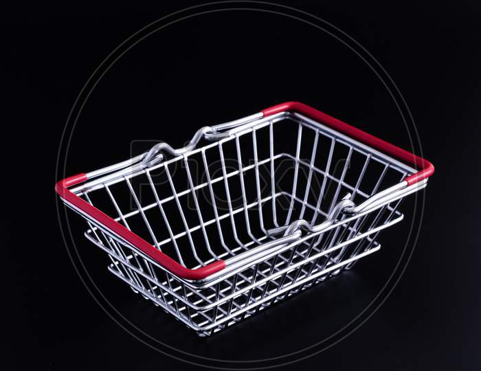 Tiny Metal Shopping Basket Against Black Background