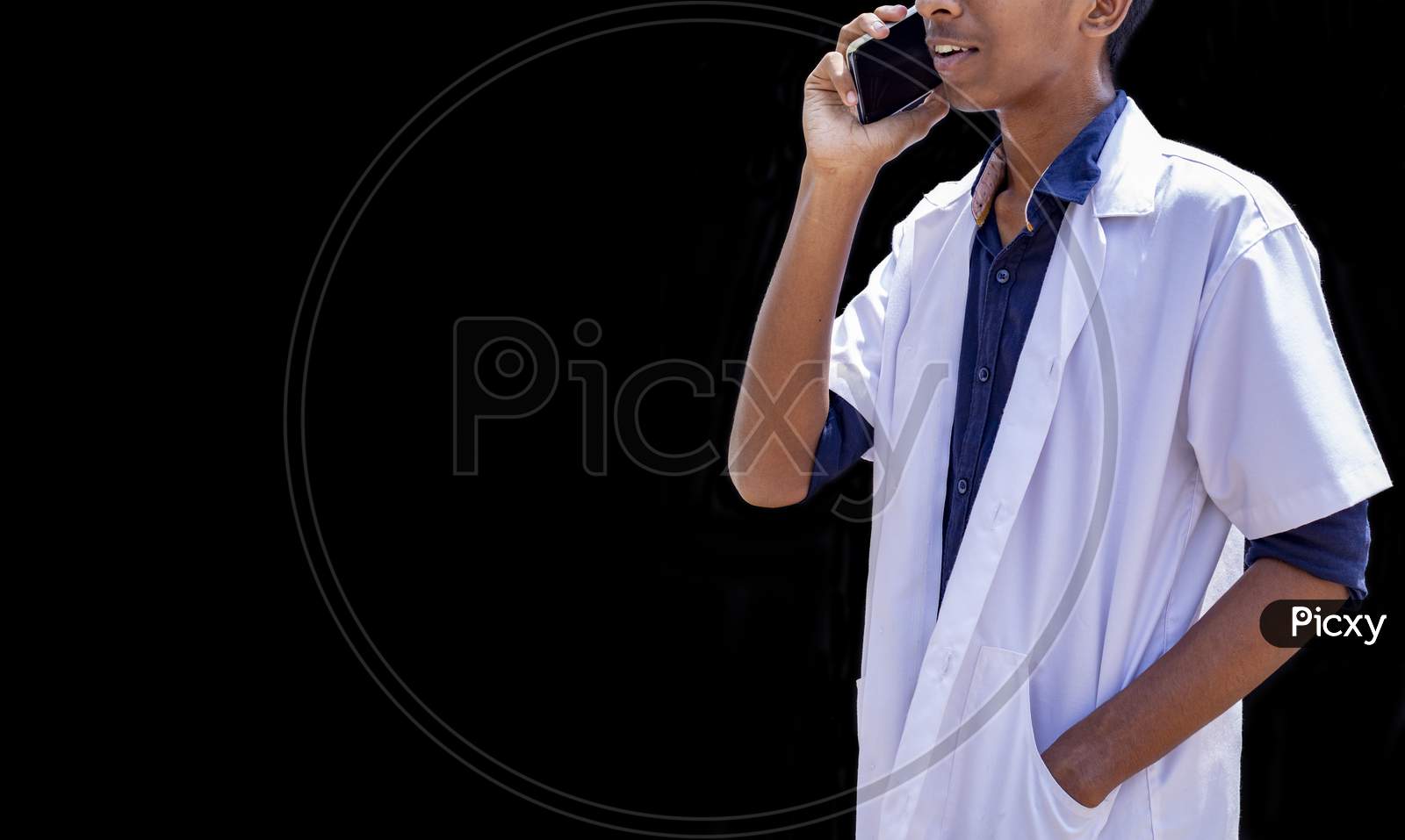 Cropped Shot Of Male Doctor Speaking On The Smart Phone, Standing Isolated Over Black Backgrounds