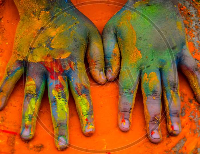 a pair of painted hands during Holi the festival of colours