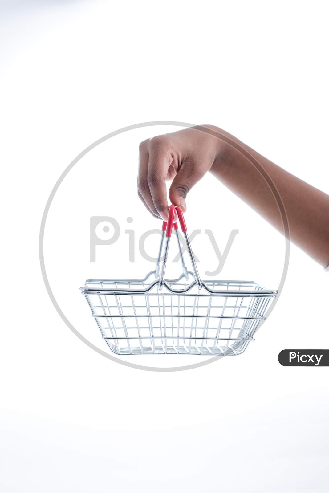 Online Shopping Concept, Sale. Hand Holding Mini Shopping Basket On White Background. Side View