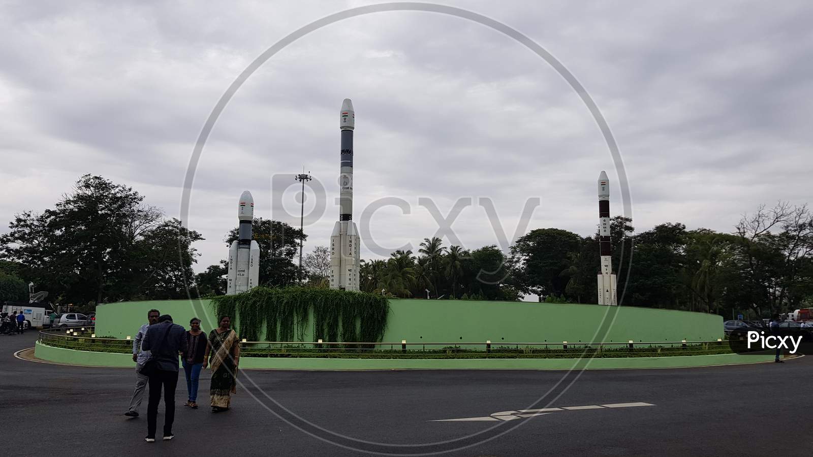 Sriharikota, Andhra Pradesh, India - July 22 2019: Visitors at the entrance of 'Satish Dhawan Space Research Center' that belongs to ISRO on a cloudy day with the mock rockets in the background