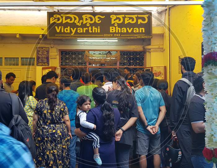 Bengaluru, Karnataka / India - November 19 2019: People waiting outisde the famous hotel 'Vidyarthi Bhavan' also written in local language 'Kannada' above.