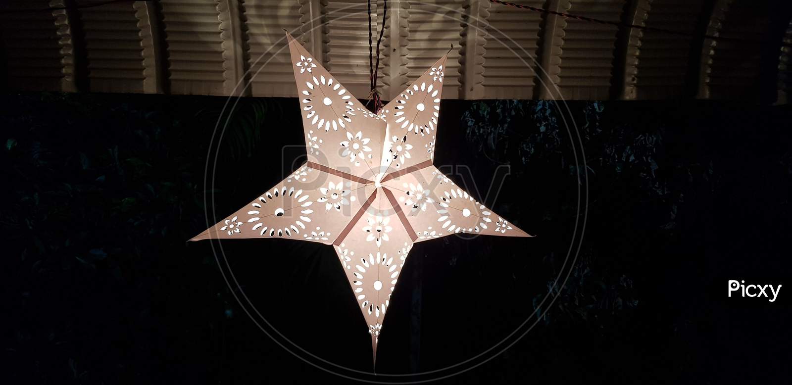 Closeup of a decorative plastic star hanging from the roof