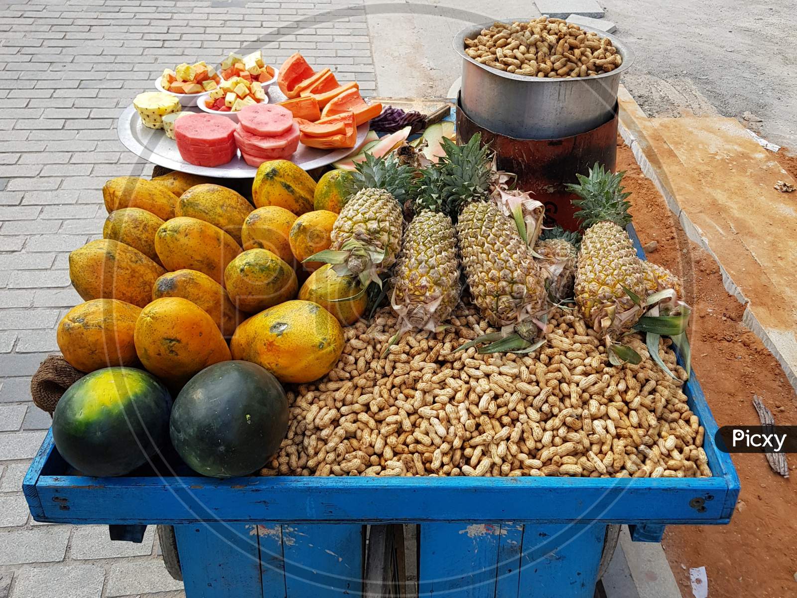 Indian Street Food Vendor Selling Peanuts And Fruit Bowls