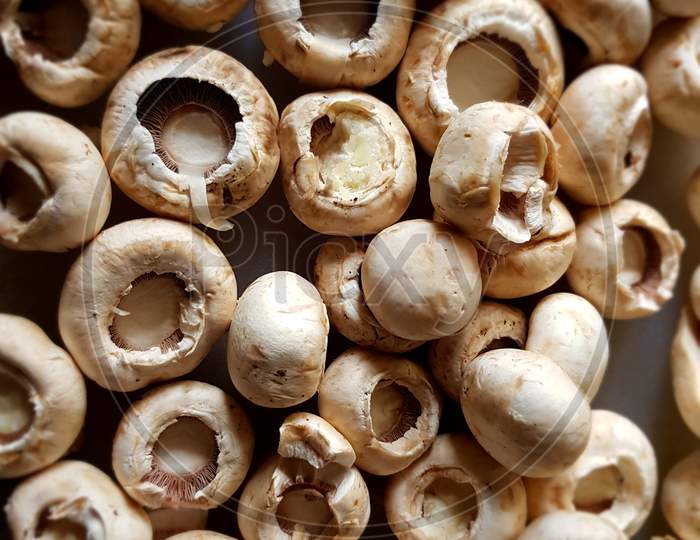 closeup of button mushrooms cut and ready to be cooked