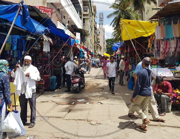 Bengaluru, Karnataka / India - November 19 2019: People walking down the streets on Shivaji nagar in the noon time shopping for dress and fancy items