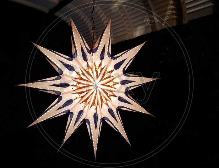 Closeup of a decorative plastic star hanging from the roof