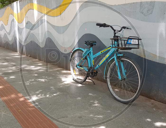 Bengaluru, Karnataka, India - November 15 2019: A rental bike/cycle parked on the footpath during day time