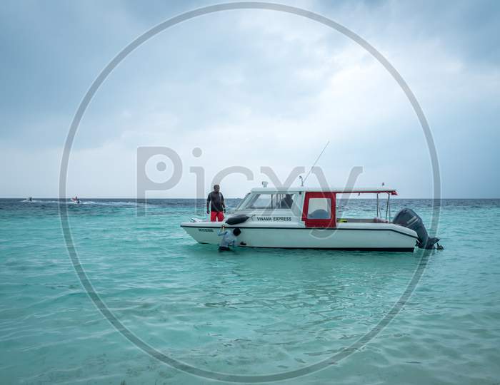 A small fishing boat anchored at Maafushi island, Maldives