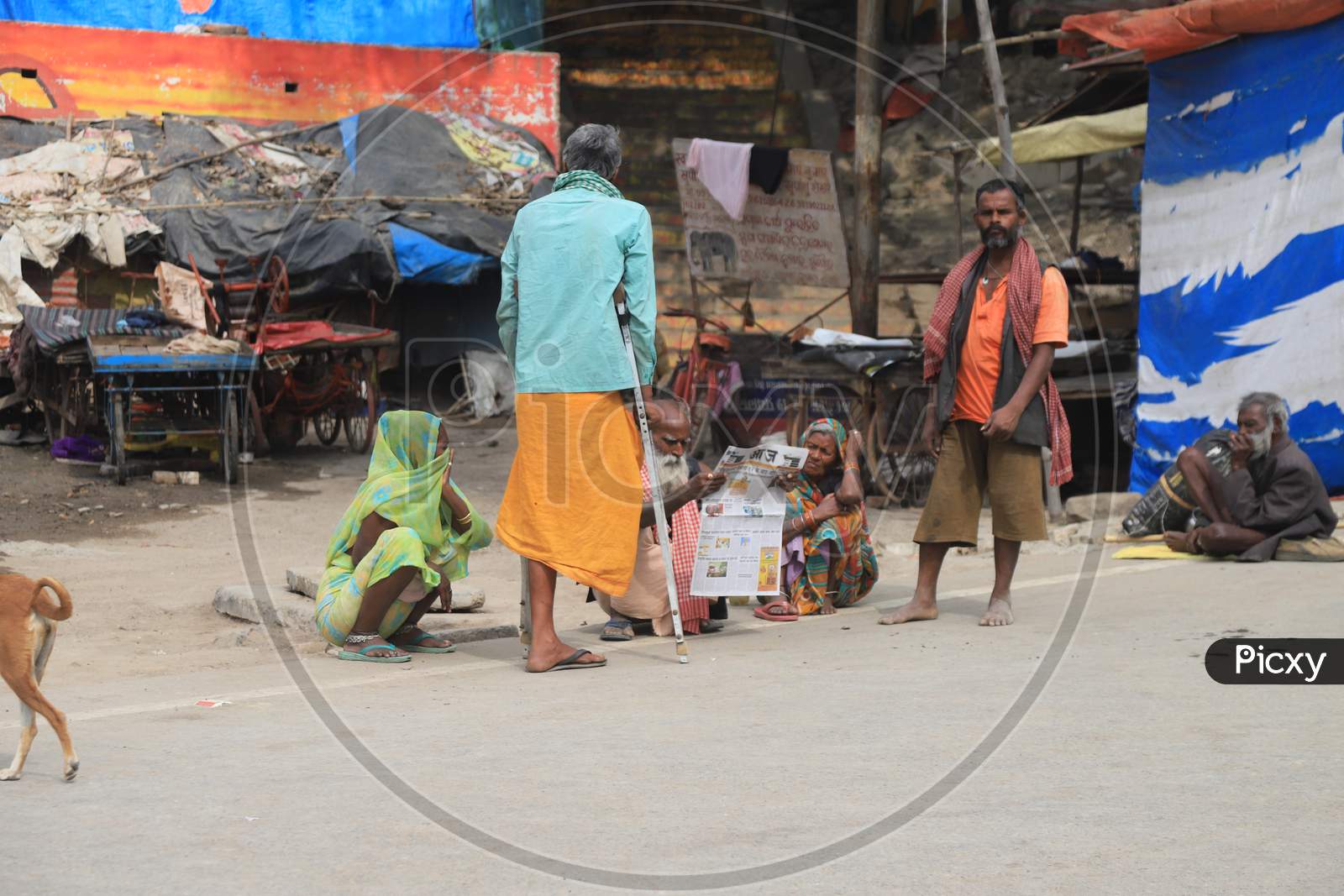 Homeless People Site Inside Circles Drawn On A Road For People To Maintain Safe Distance To Eat Food?During A 21-Day Nationwide Lockdown To Slow The Spreading Of Coronavirus Disease (Covid-19) In Prayagraj, April 8, 2020.