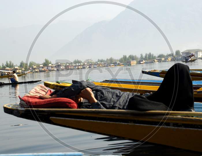 Dal Lake, A Boat man Sleeping In a Boat at Dal Lake Srinagar Because Of  Tourism Got Effected Due to Corona Virus Or COVID-19 Outbreak in India