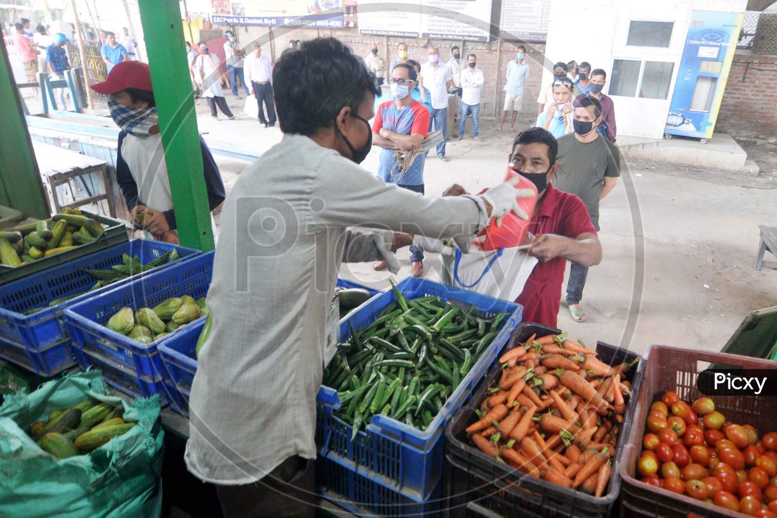Guwahati -People Maintain Social Distance As They Stand In A Queue To Buy Vegetables, Supplied By The State Food Supply Department, During A Nationwide Lockdown In The Wake Of The Corona Virus Pandemic In Guwahati On Wednesday, 8 April 2020.