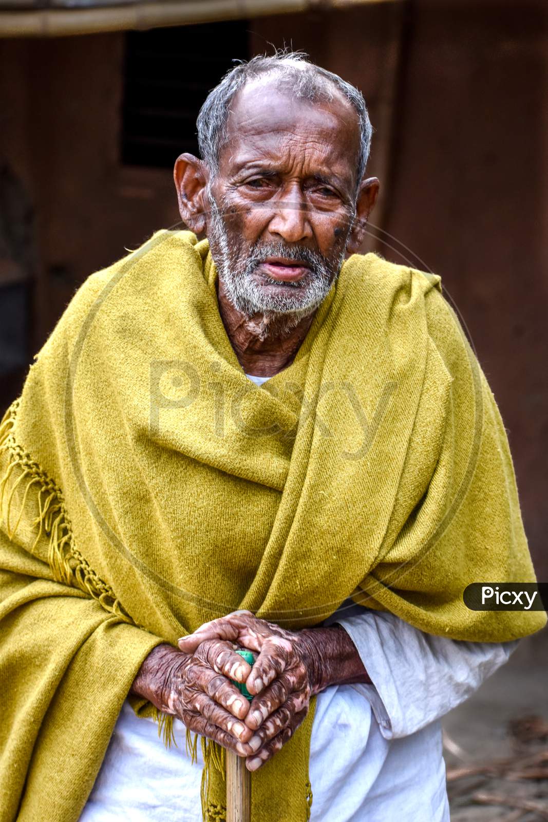 A poor and old tribal beggar of India looked in with frustration