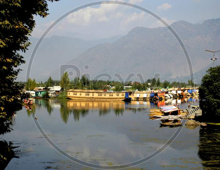 Dal Lake ,  A Calm Dal Lake With Boats in Srinagar With out Tourists Due to Corona Virus or COVID -19 Outbreak in India