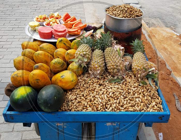 Indian Street Food Vendor Selling Peanuts And Fruit Bowls