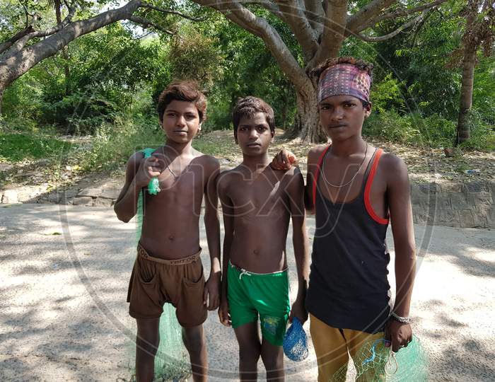 Krishnagiri, Tamil Nadu, India - 23-Dec-2018: Three young boys from the fisherman community in Tamil nadu posing with their nets