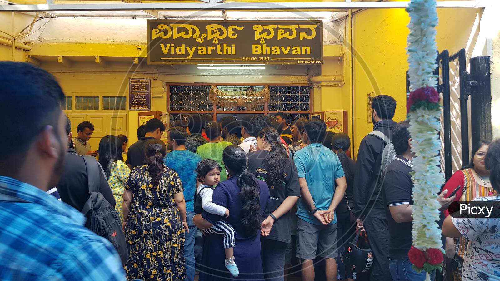 Bengaluru, Karnataka / India - November 19 2019: People waiting outisde the famous hotel 'Vidyarthi Bhavan' also written in local language 'Kannada' above.