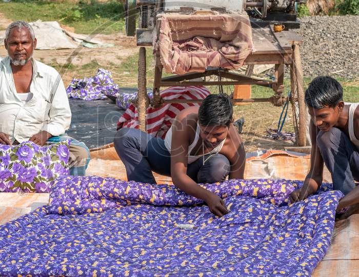 Some people from the Bihar state of India are making colorful blankets