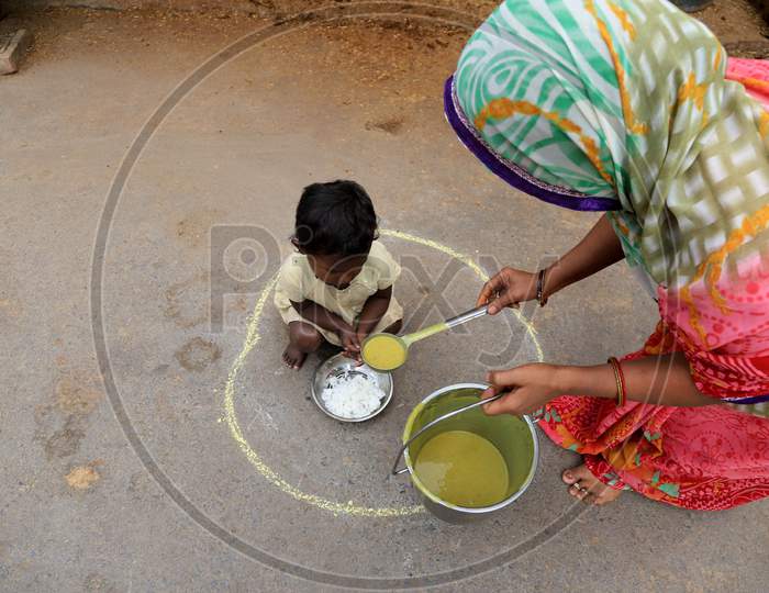 A Child Site Inside Circles Drawn On A Road For People To Maintain Safe Distance To Eat Food?During A 21-Day Nationwide Lockdown To Slow The Spreading Of Coronavirus Disease (Covid-19) In Prayagraj, April 8, 2020.