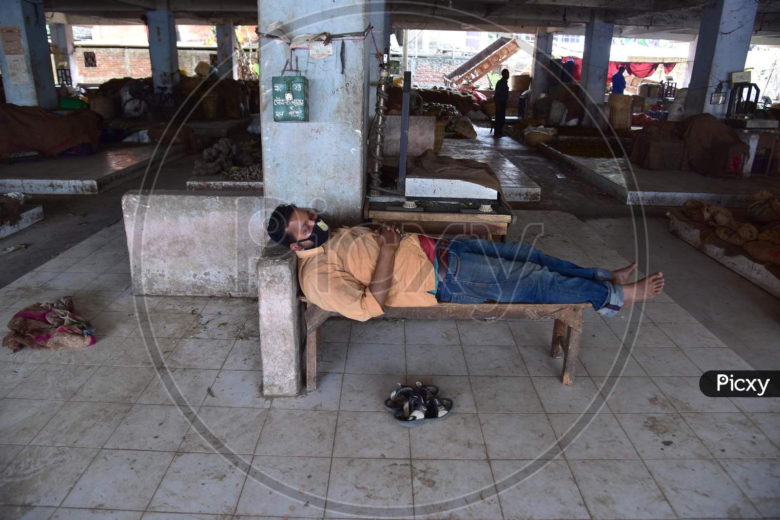 Nagaon ,India-April 08,2020: A Vendor Sleeps  At A Wholesale Fruits And Vegetable Market During A Nationwide Lockdown Imposed In The Wake Of Coronavirus Pandemic, In Nagaon District Of Assam ,India
