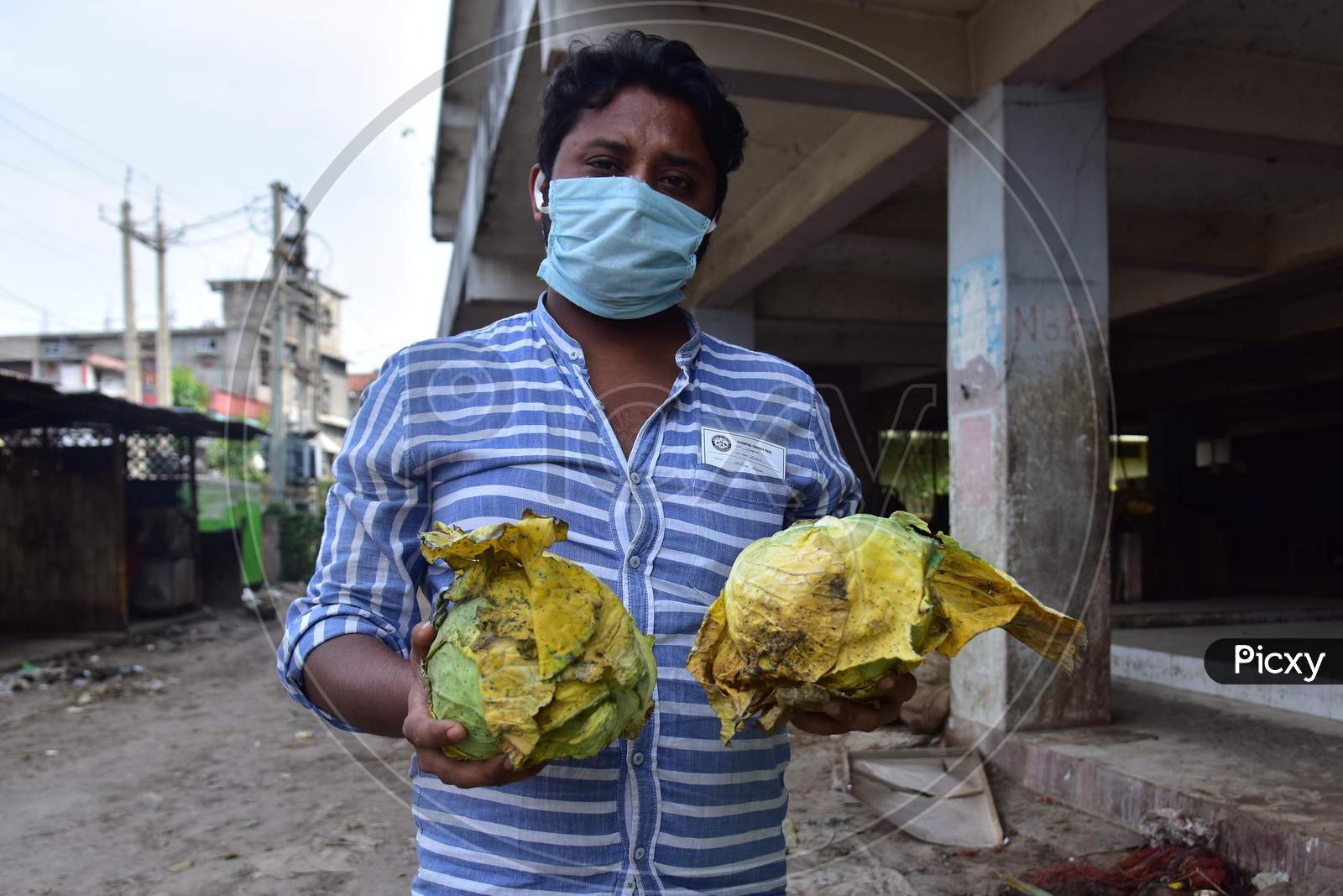 Nagaon,India-April 08,2020:A Vendor Show His  Damaged Vegetables At A Wholesale Vegetable Market During A Nationwide Lockdown Imposed In The Wake Of Coronavirus Pandemic, In Nagaon District Of Assam ,India