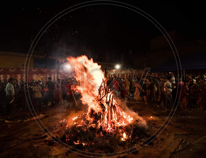 Bengaluru, Karnataka, India - 20-Mar-2019: People celebrating the Hindu festival Holika Dahan the night before Holi