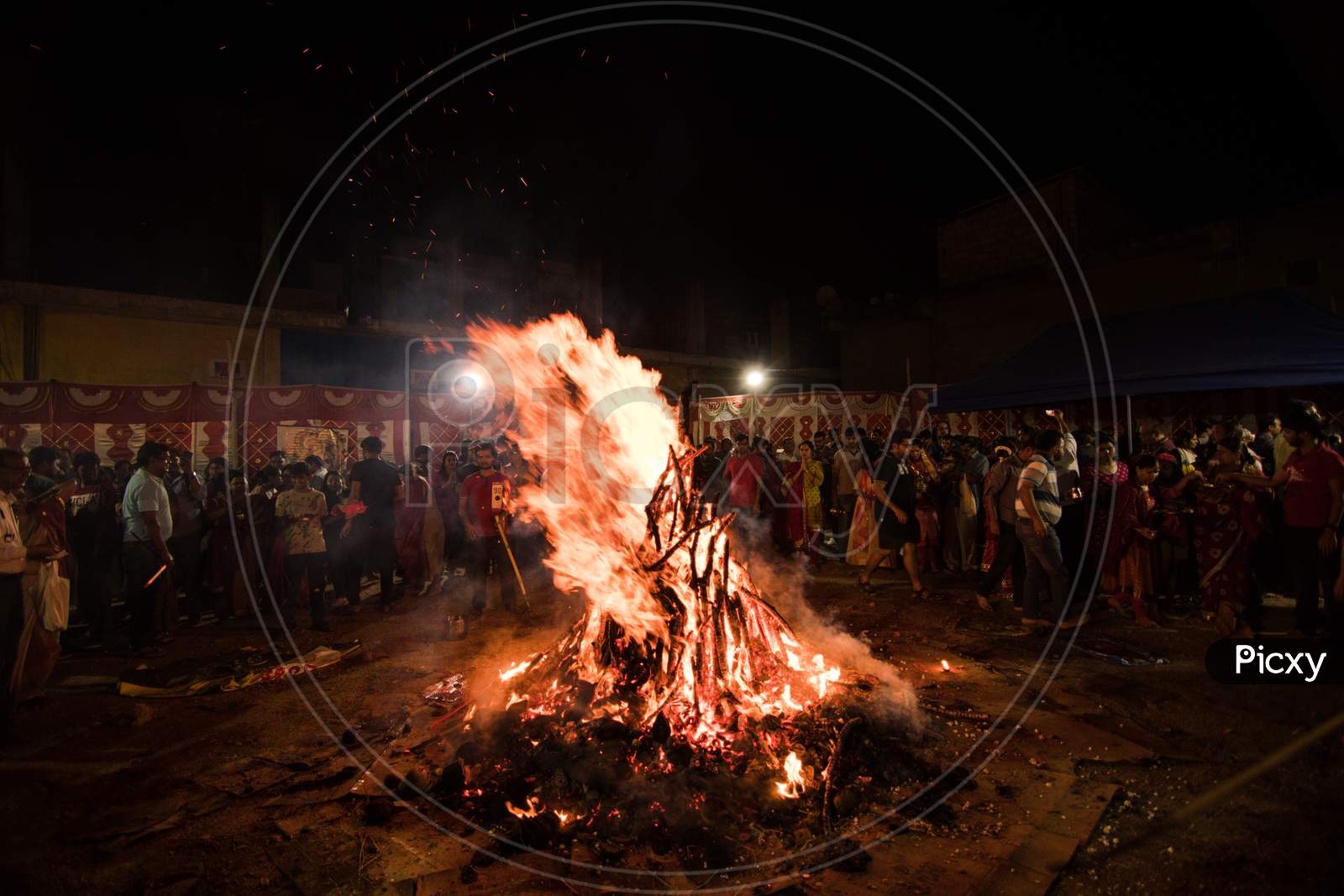 Bengaluru, Karnataka, India - 20-Mar-2019: People celebrating the Hindu festival Holika Dahan the night before Holi