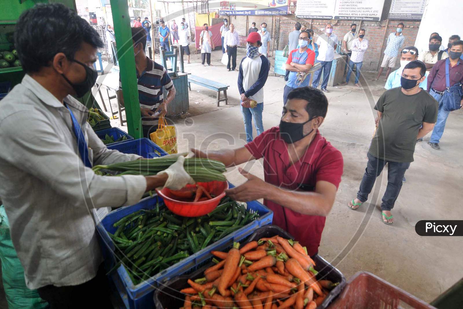 Guwahati -People Maintain Social Distance As They Stand In A Queue To Buy Vegetables, Supplied By The State Food Supply Department, During A Nationwide Lockdown In The Wake Of The Corona Virus Pandemic In Guwahati On Wednesday, 8 April 2020.