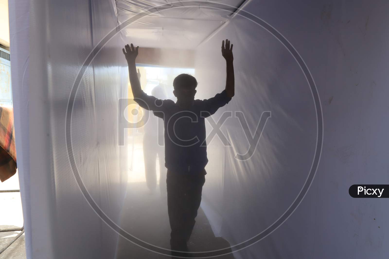 Employees Entering Through Disinfectant Tunnel  or Self Sanitizing Tunnels Arranged At Government Offices During 21-day Lock down Period Due To Corona Virus Or COVID-19 Outbreak in India. Prayagraj