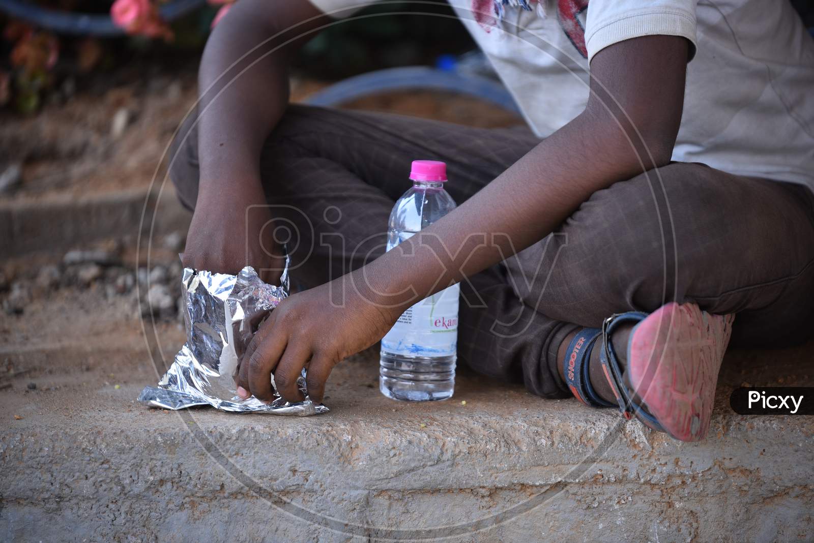 a migrant worker's son eats food that is distributed by donors during nationwide lockdown amid coronavirus pandemic, April 8,2020, Hyderabad.