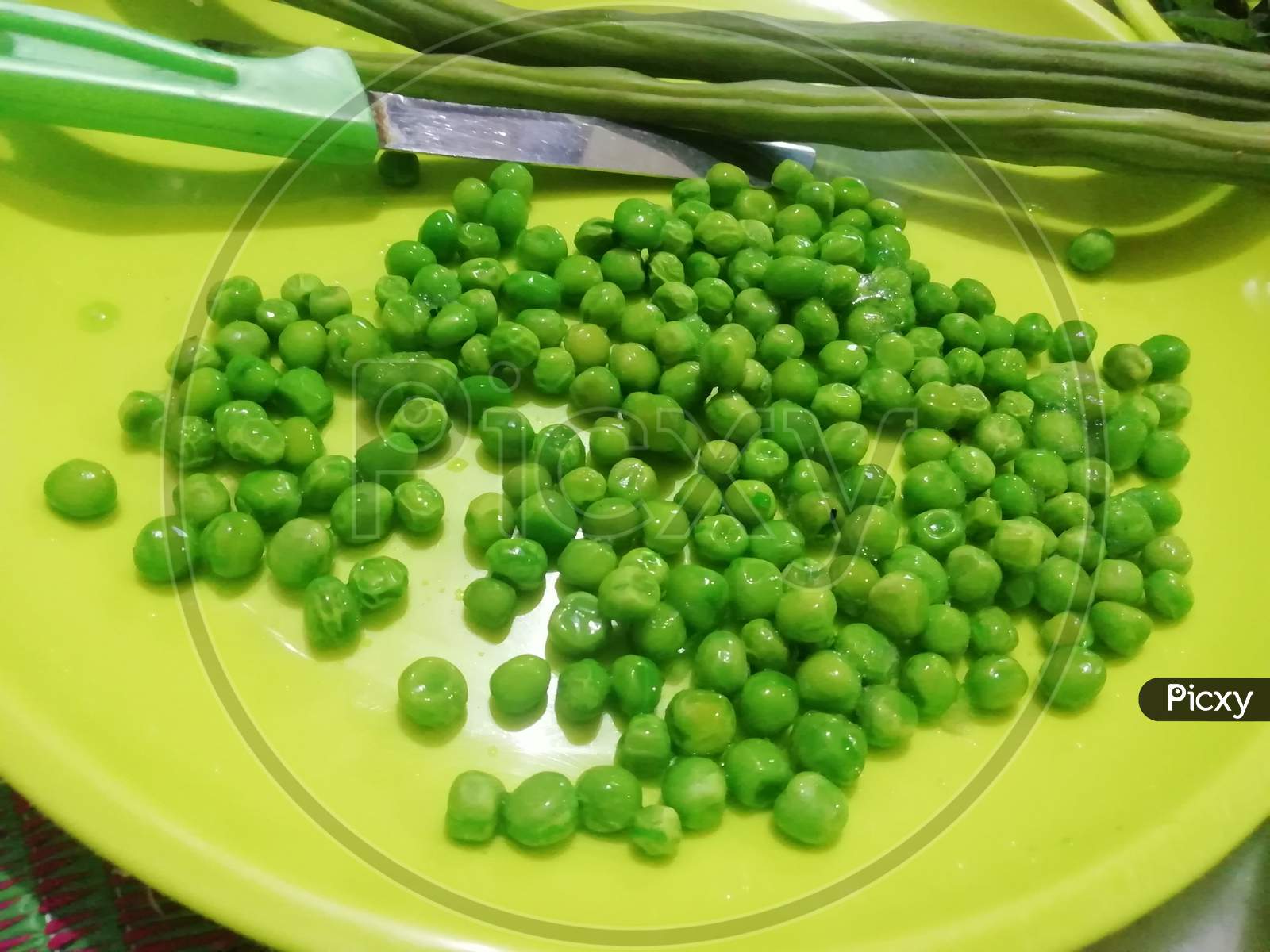Green peas in a yellow plate